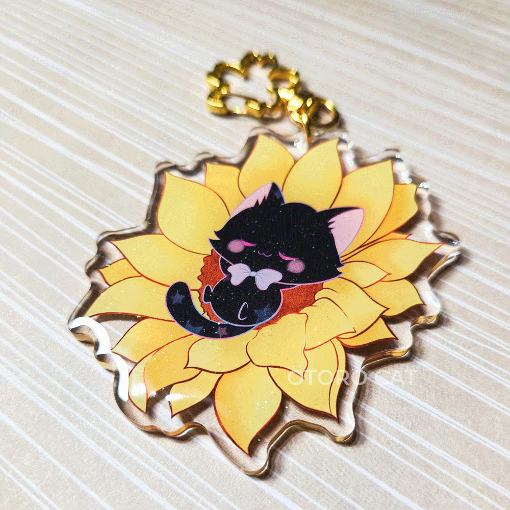 Alt Description: "Black Cat Keychain - A charming keychain depicting a black cat peacefully lounging on a vibrant sunflower. This adorable and stylish keychain is a must-have for cat lovers, combining feline grace with the beauty of nature. Order your black cat keychain today and carry a touch of whimsy wherever you go!