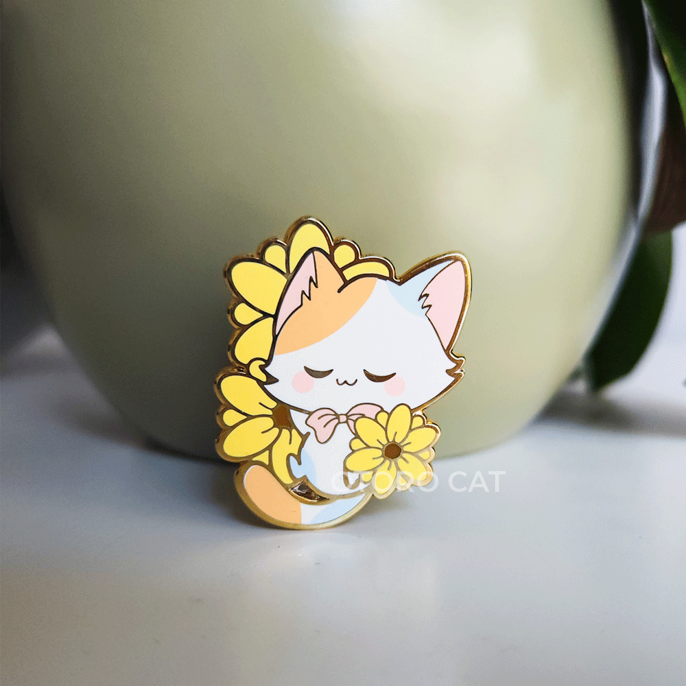 Adorable Calico Cat Laying on Sunflower Hard Enamel Pin - A charming hard enamel pin featuring a calico cat lounging on a vibrant sunflower. This cute pin adds a touch of whimsy and nature-inspired beauty to your collection. Perfect for cat lovers and enamel pin enthusiasts. Order yours today!